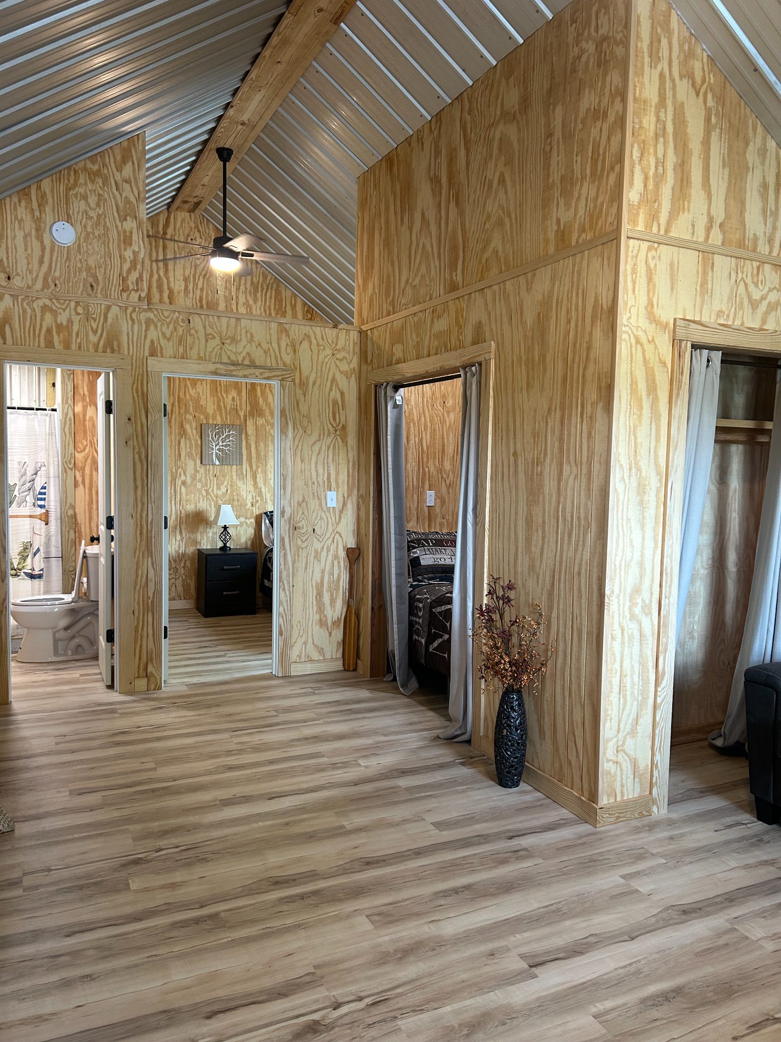 Open interior showing bedroom doorways and vaulted ceiling