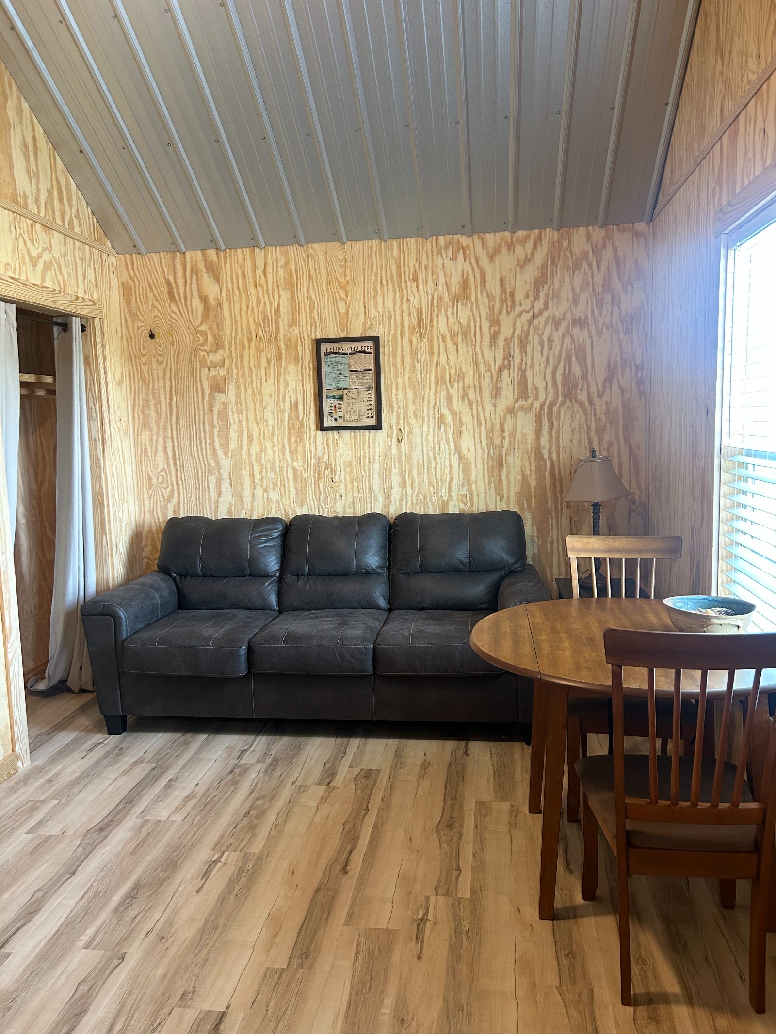 Living area with sofa and dining table inside a Buckhill cabin