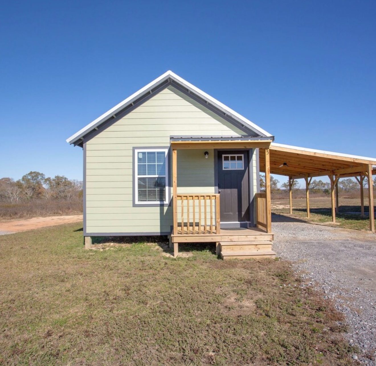 Cabin exterior with porch and covered carport